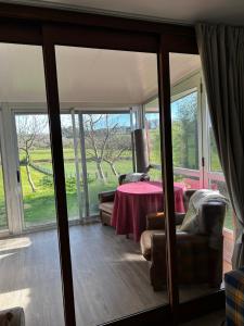 a room with a table and chairs and sliding glass doors at Casa O Pazo - Rural - Camino Norte - Boimorto in Boimorto