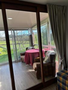 a living room with a table and chairs and sliding glass doors at Casa O Pazo - Rural - Camino Norte - Boimorto in Boimorto