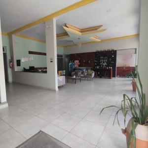 a large room with a large white tile floor at Hotel Portal Triunfo in Triunfo