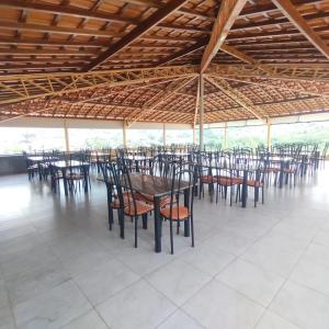 a group of tables and chairs in a pavilion at Hotel Portal Triunfo in Triunfo