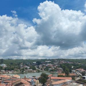 a view of a city with a river and clouds at Hotel Portal Triunfo in Triunfo