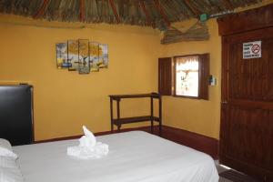 a bedroom with a bed and a window at Cabañas "El jardín del Edén" in Valladolid