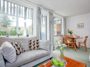 a living room with a couch and a table at Tuckenhay, Mill Leat - Fcv in Ashsprington