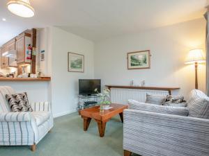 a living room with two couches and a tv at Tuckenhay, Mill Leat - Fcv in Ashsprington +37 photos