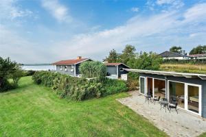 a house on the beach with a yard at 30711-Odder-Skovgardsparken-1 in Odder
