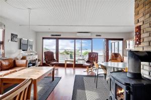 a living room with a couch and a fireplace at 30711-Odder-Skovgardsparken-1 in Odder