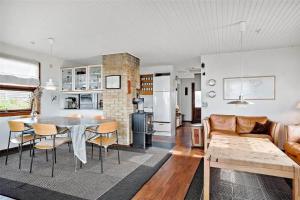 a kitchen and living room with a table and chairs at 30711-Odder-Skovgardsparken-1 in Odder