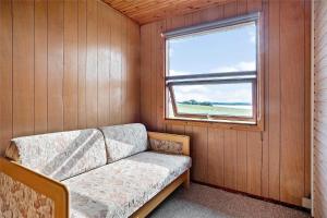a couch sitting in a room with a window at 30711-Odder-Skovgardsparken-1 in Odder
