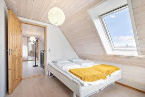 a bed in a room with a window at 10253-Ulfborg-Sognegardsvej-13 in Ulfborg