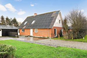 a red brick house with a black roof at 10253-Ulfborg-Sognegardsvej-13 in Ulfborg