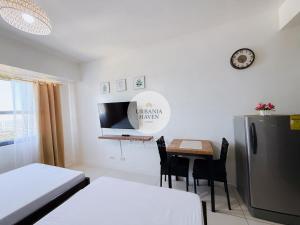 a white room with a table and a refrigerator at Urbania Haven Cebu2 in Cebu City
