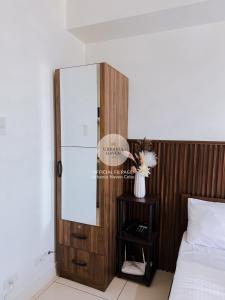 a bedroom with a mirror next to a bed at Urbania Haven Cebu2 in Cebu City