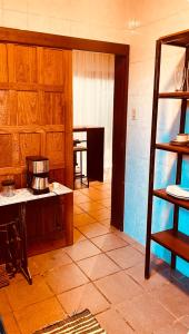 a kitchen with wooden cabinets and a table in a room at Refúgio do Ipê Rosa in Tubarão