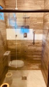 a bathroom with a shower with a toilet at Refúgio do Ipê Rosa in Tubarão +8 photos