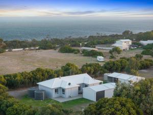 an aerial view of a house and the ocean at CandE on Samphire in Kingscote