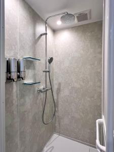 a bathroom with a shower with a shower head at yucurum in Itoman +39 photos