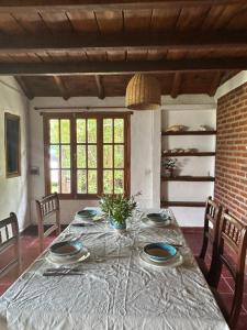 a dining room with a table with plates on it at La Cabaña de Caro in Mar de Cobo