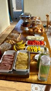 a table with many different types of food on it at Pousada Iraquara in João Pessoa