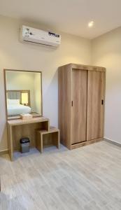 a room with a vanity and a mirror at Alturya in Al-ʿUla