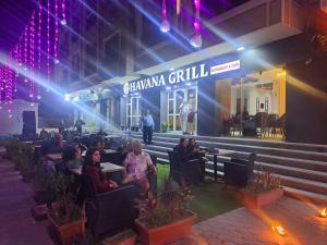 a group of people sitting in chairs in front of a building at Juliana Beach Hurghada in Hurghada +86 photos