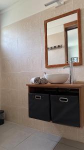 a bathroom with a sink and a mirror at Zabitant Lodge Éliane in Vieux-Habitants +4 photos