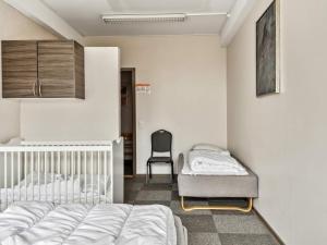 a bedroom with a bed and a chair in it at Expansive Villa near Ribe in Skærbæk +19 photos