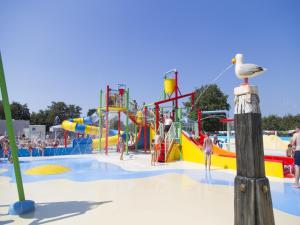 a large water park with people playing in it at Bright Beachside Base in Burgh-Haamstede in Burgh Haamstede
