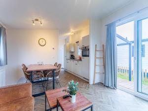 a kitchen and living room with a table and chairs at Bright Beachside Base in Burgh-Haamstede in Burgh Haamstede