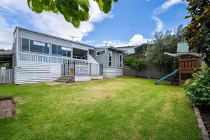 an image of a house with a yard at 550m to Beach, SPA and Large Backyard , Sleep 9 in Ocean Grove