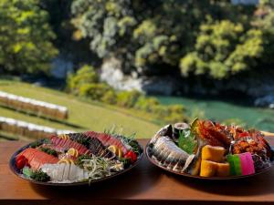 two plates of food sitting on top of a table at Tiny House - Vacation STAY 12059v in Ōtakuchi