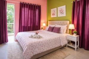 a bedroom with a bed with pink and green walls at Singh ManSion in Purnea