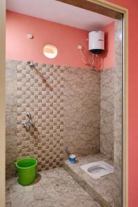 a bathroom with a shower with a toilet in it at Singh ManSion in Purnea +2 photos