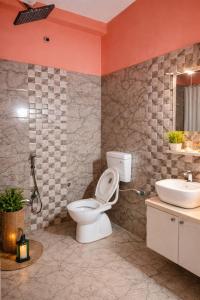 a bathroom with a toilet and a sink at Singh ManSion in Purnea