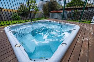 a hot tub sitting on a deck with blue water at 550m to Beach, SPA and Large Backyard , Sleep 9 in Ocean Grove