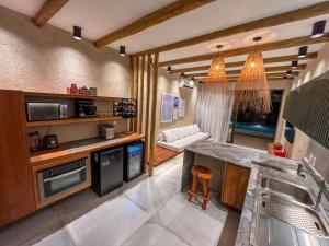 a kitchen with a sink and a counter top at Brisa e Sal in São Miguel dos Milagres