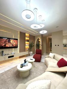 a living room with a couch and a tv at Luxury 2 Bedroom Apartment with 2 Private Patios in Lekki Phase 1 in Lekki