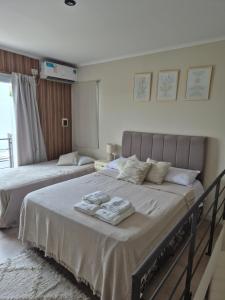 a bedroom with two beds with towels on them at ByF apart duplex excepcional en complejo Amaiur DPTO N5 Av Alem Norte in Federación +63 photos