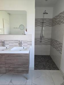 a bathroom with a sink and a shower at Villa Marie in Graignes +13 photos