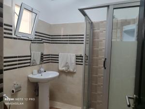 a bathroom with a sink and a shower at maison achab in Asilah