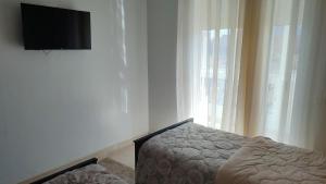a bedroom with a bed and a flat screen tv at maison achab in Asilah