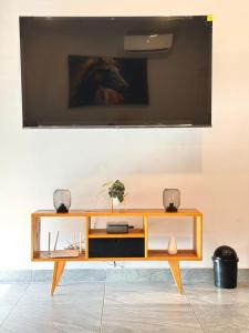 a living room with a television on a wall at Comfort stay Mazatlan in Mazatlán
