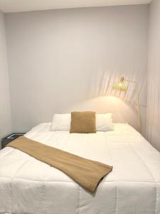 a white bed with a blanket on top of it at Comfort stay Mazatlan in Mazatlán +39 photos