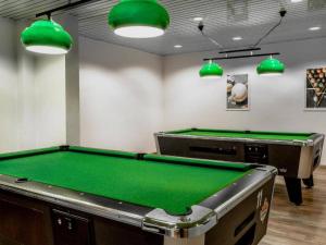 a pool table in a room with green at Kaiserhof Feldberg- Standard Double Room in Feldberg