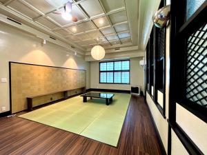 a large room with a ping pong table in it at mahoratto inn in Aomori