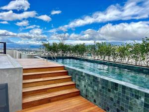 a swimming pool with stairs leading up to a house at Babylon Prime Nunciatura in San José