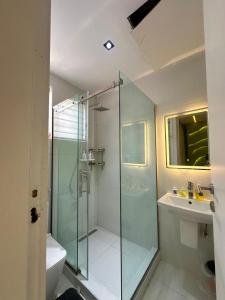a bathroom with a glass shower and a sink at Luxury 2 Bedroom Apartment with 2 Private Patios in Lekki Phase 1 in Lekki +41 photos
