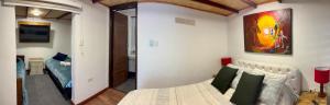a bedroom with a bed and a painting on the wall at Casa campestre Hotel Cerro Fuerte in Sopo +17 photos