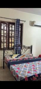 a bedroom with a bed with a quilt on it at Monica guest house in Varca