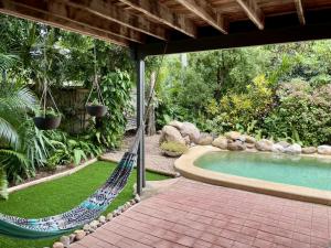 a patio with a hammock next to a swimming pool at Horseshoe Haven in Horseshoe Bay