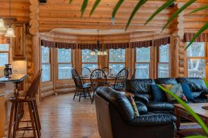 a living room with a couch and a table at Fiddler Lake Resort - Deer 80 in Mille-Isles